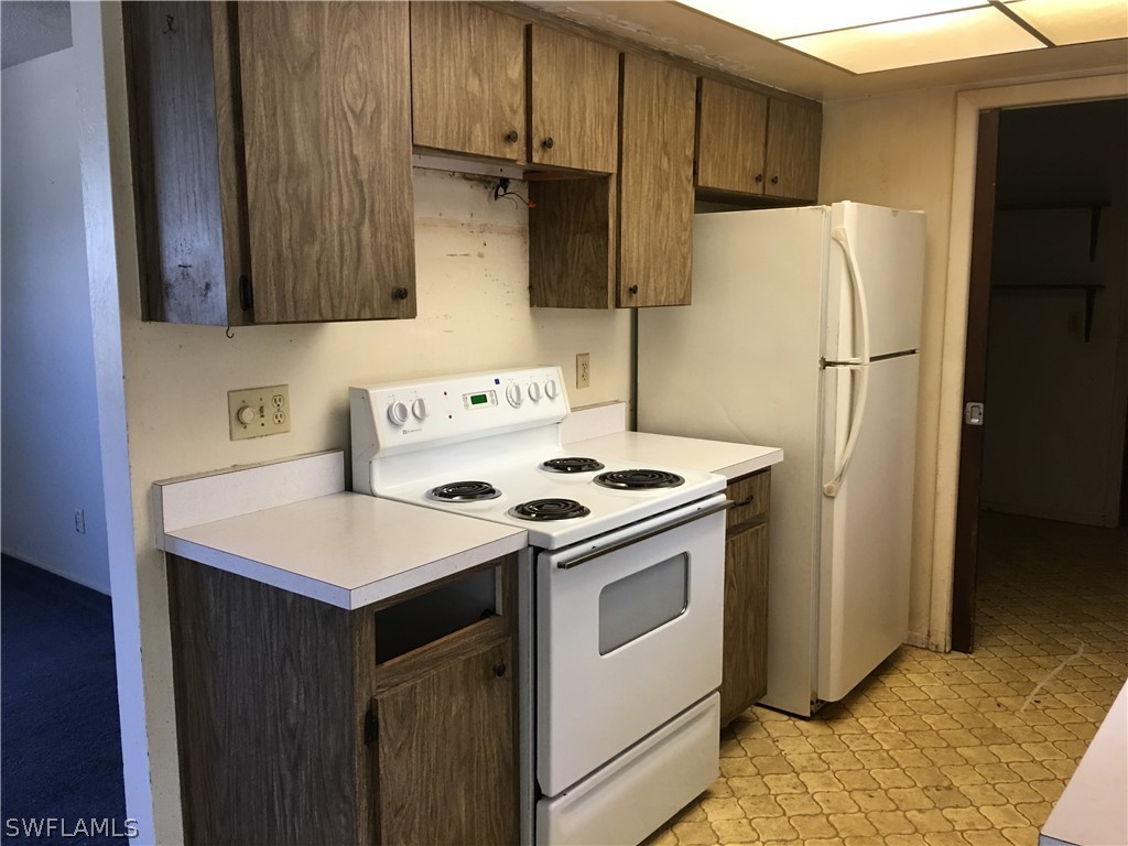 7229 Myrtle Road Fort Myers, FL 33967 - Photo 6 of 15 a kitchen with a white stove top oven and refrigerator