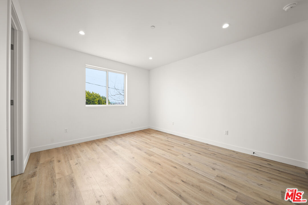 1520 Magnolia Avenue, Unit 1 Los Angeles, CA 90006 - Photo 13 of 21 an empty room with wooden floor and windows