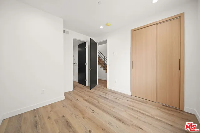 a view of hallway with wooden floor