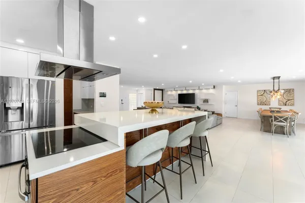 a kitchen with stainless steel appliances kitchen island granite countertop a sink and cabinets