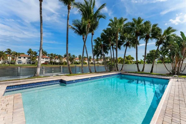 a view of swimming pool with a table and chairs