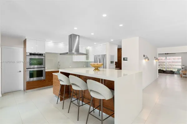 a large kitchen with a table and chairs in it