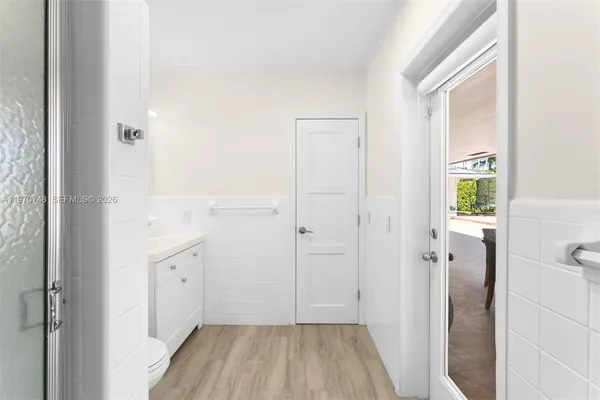 a view of a hallway with wooden floor and closet