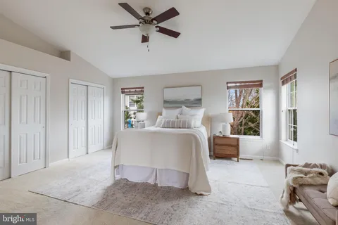 a bedroom with a bed and glass window