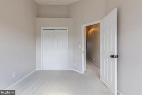 an empty room with closet and a bathroom