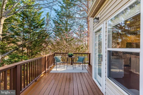 a view of balcony with a large window and wooden floor