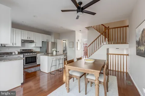 a kitchen with sink cabinets and wooden floor