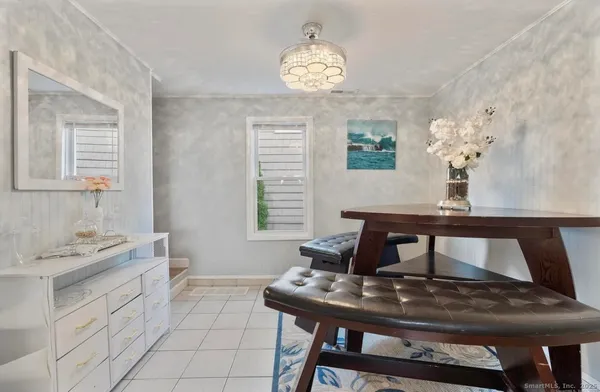 a view of a dining room with furniture and a chandelier