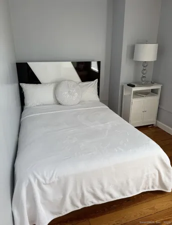a large white bed in a white room