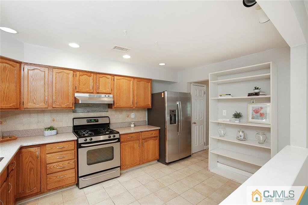 1901 Timber Oaks Road Edison, NJ 08820 - Photo 12 of 23 a kitchen with stainless steel appliances a refrigerator and a stove top oven