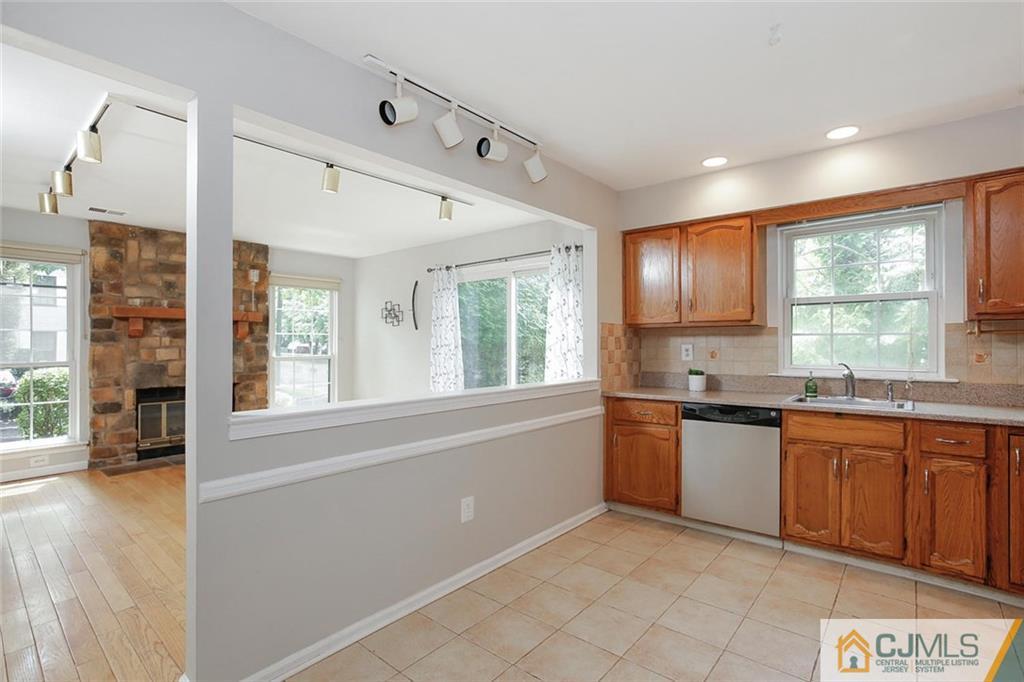 1901 Timber Oaks Road Edison, NJ 08820 - Photo 13 of 23 a large kitchen with stainless steel appliances granite countertop a refrigerator a sink dishwasher a stove and white countertops with wooden floor