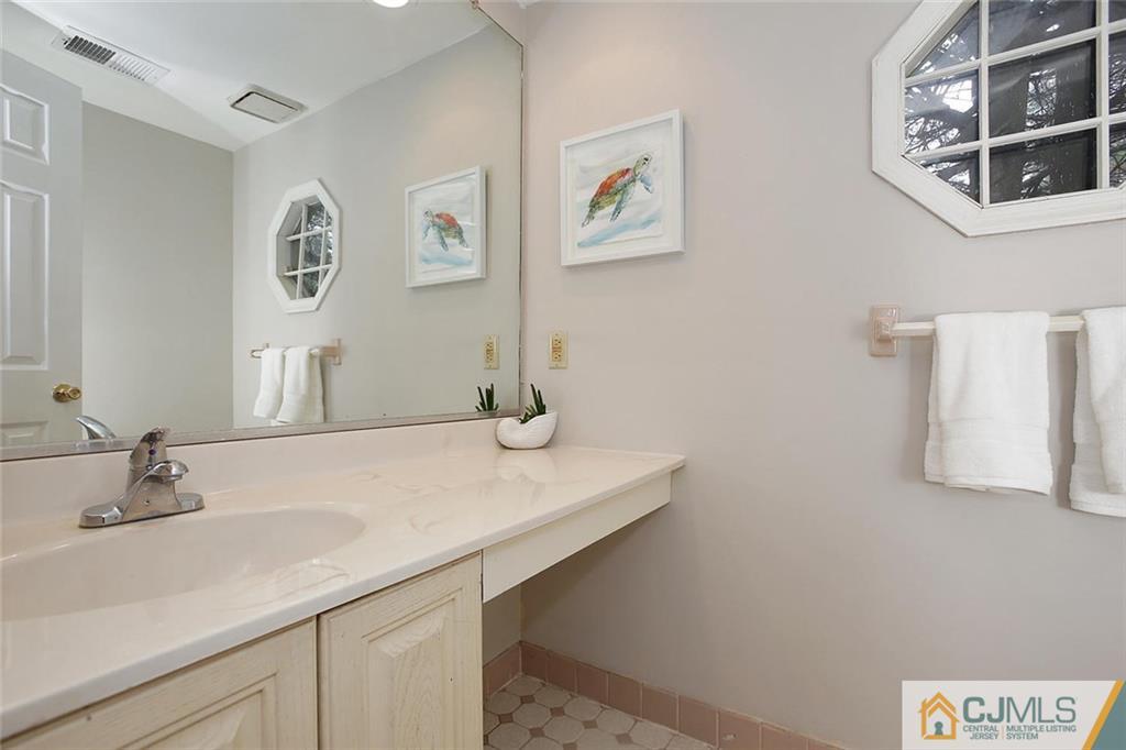 1901 Timber Oaks Road Edison, NJ 08820 - Photo 14 of 23 a bathroom with a sink and a mirror