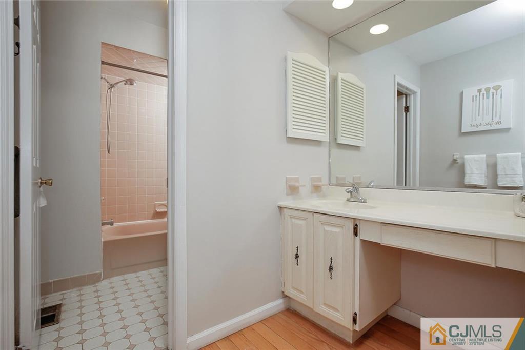 1901 Timber Oaks Road Edison, NJ 08820 - Photo 18 of 23 a bathroom with a sink a mirror and a shower