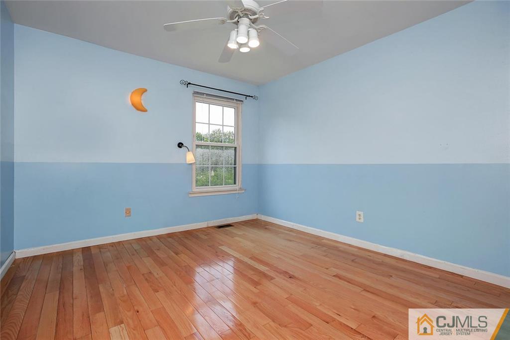 1901 Timber Oaks Road Edison, NJ 08820 - Photo 19 of 23 an empty room with windows and chandelier fan
