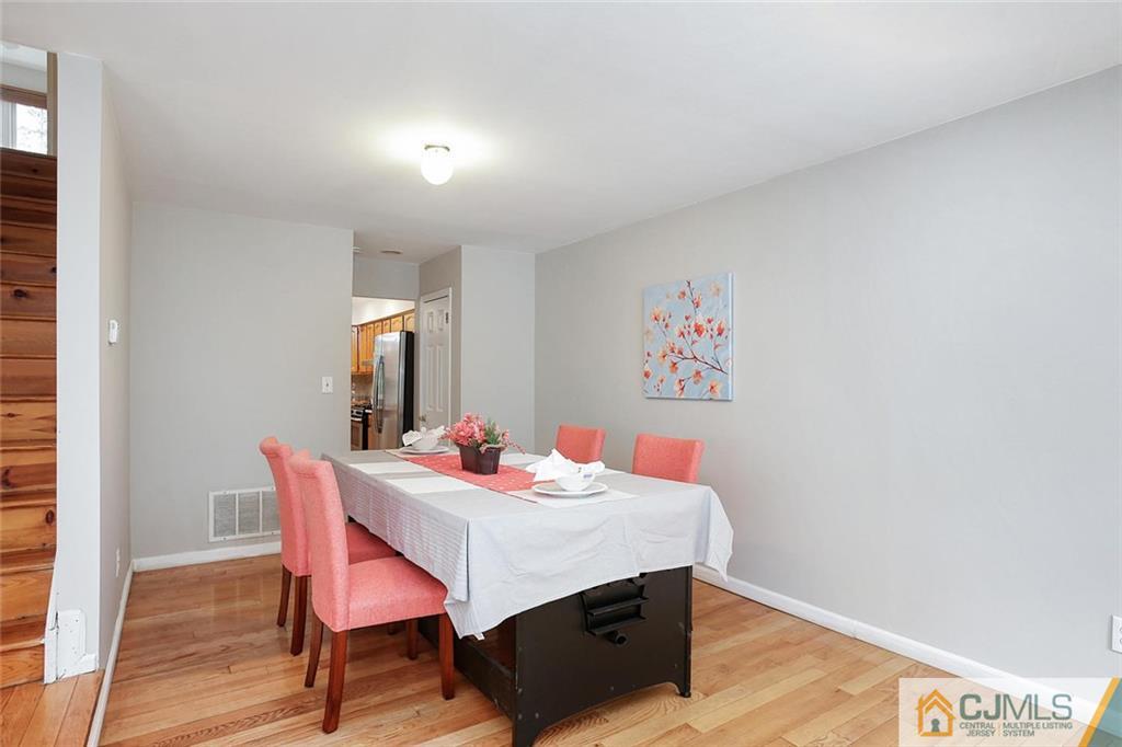 1901 Timber Oaks Road Edison, NJ 08820 - Photo 7 of 23 a view of a dining room with furniture and wooden floor