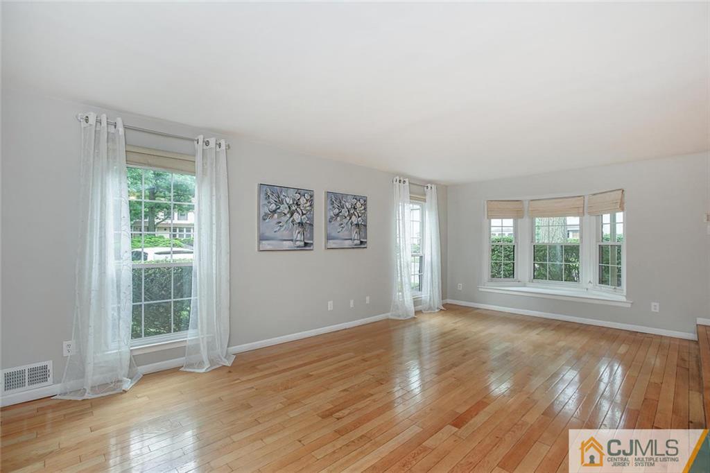 1901 Timber Oaks Road Edison, NJ 08820 - Photo 8 of 23 a view of an empty room with wooden floor and a window