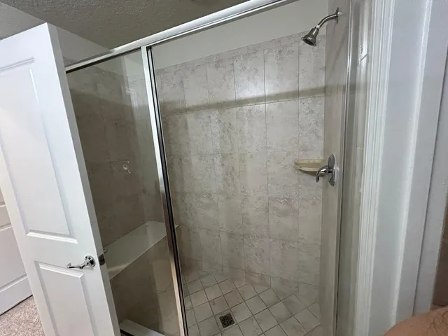 a bathroom with a glass door shower