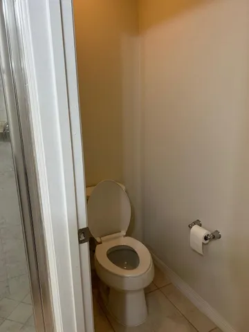 a white toilet sitting next to a sink