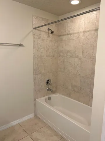 a bathroom with a shower and a bath tub
