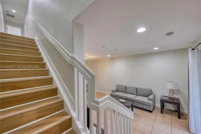 a living room with furniture and a stairs