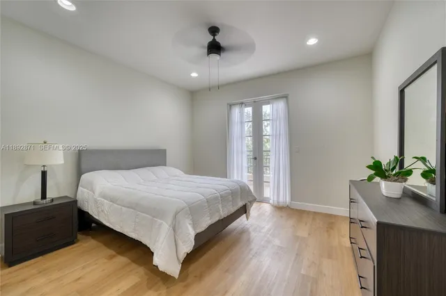 a spacious bedroom with a bed and a potted plant