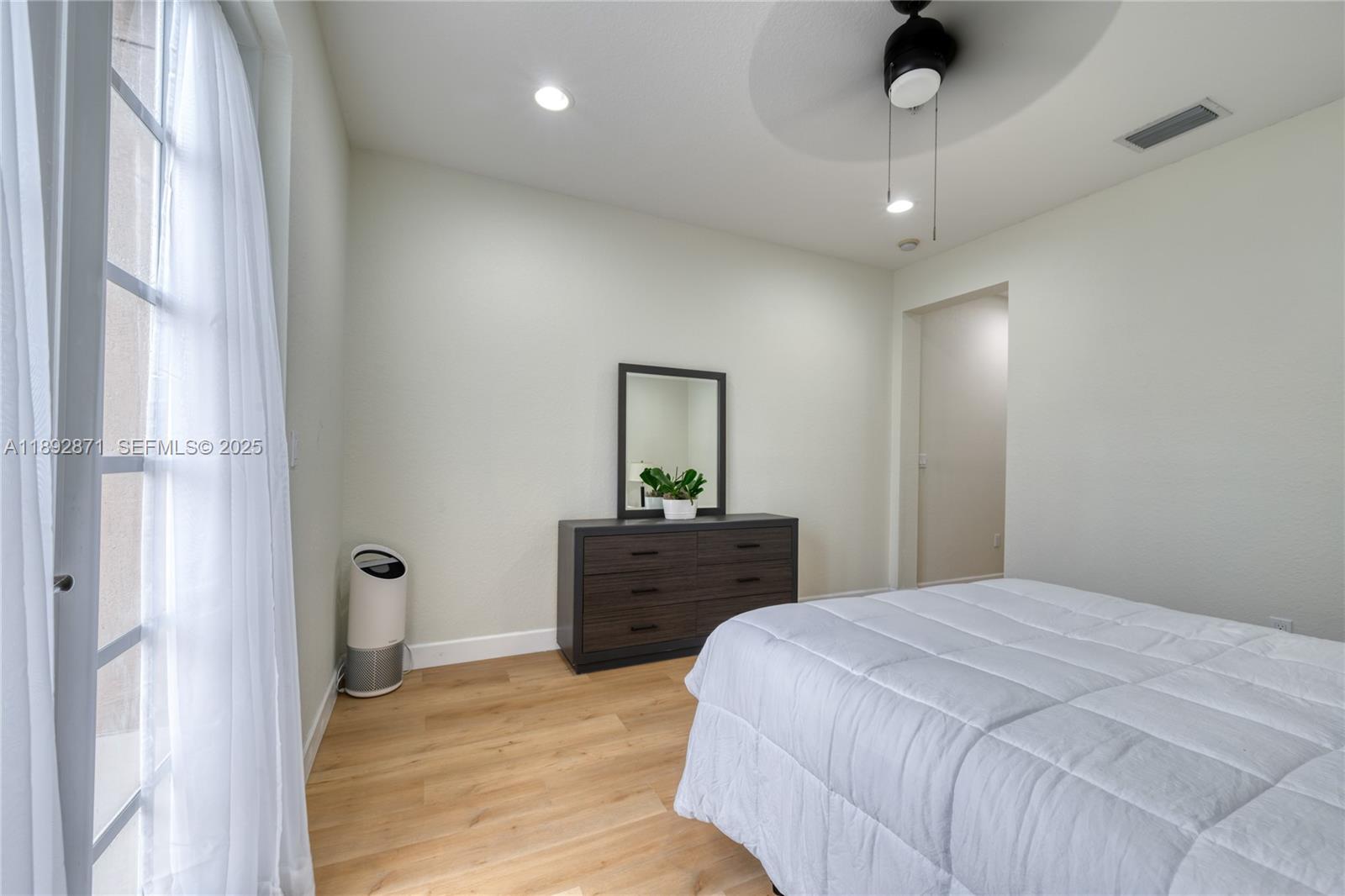 430 Southwest 147th Avenue Pembroke Pines, FL 33027 - Photo 20 of 36 a spacious bedroom with a bed and a dresser