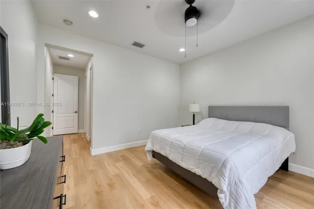 a bedroom with a bed and a potted plant
