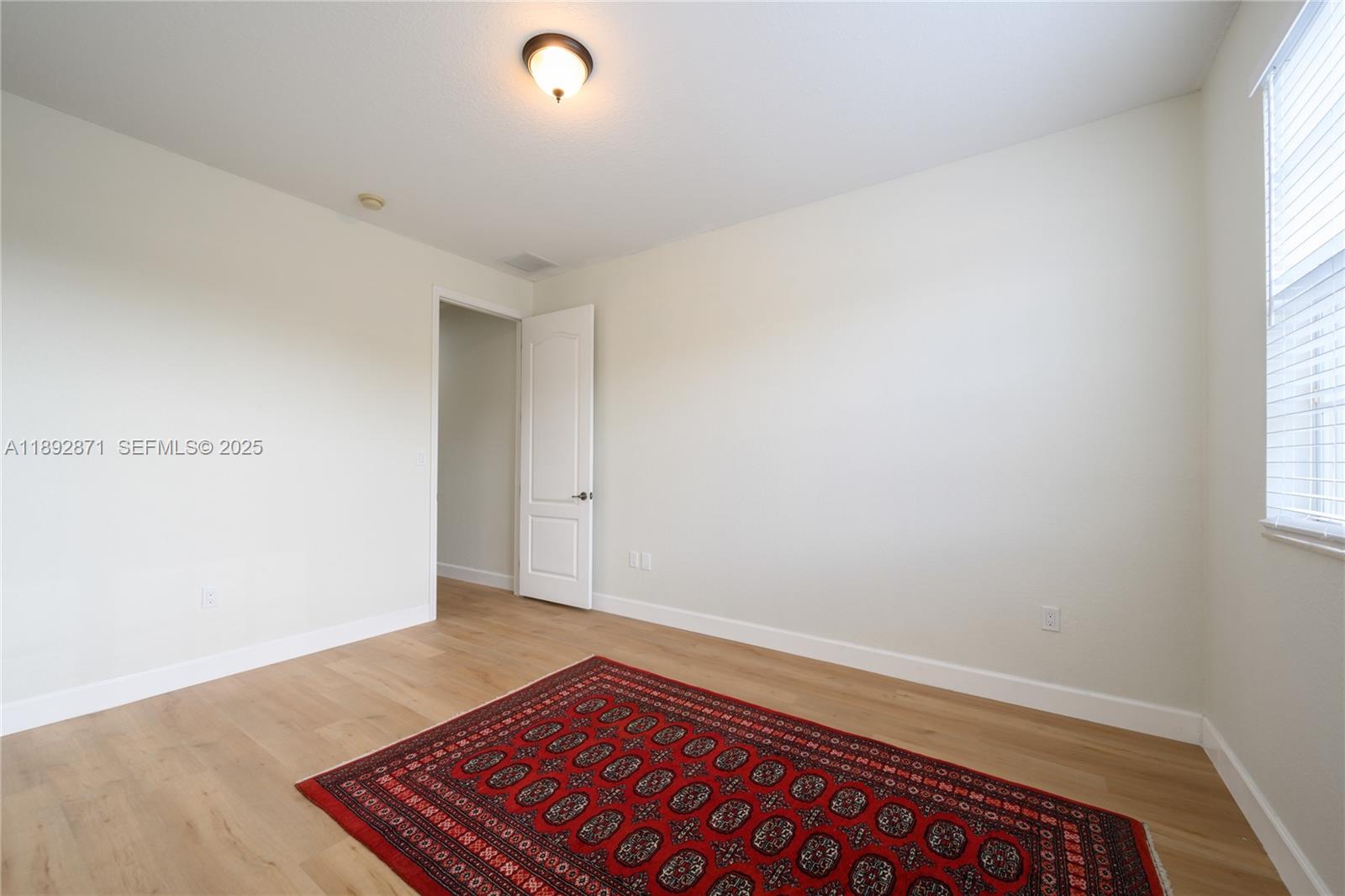 430 Southwest 147th Avenue Pembroke Pines, FL 33027 - Photo 25 of 36 a view of room with window and wooden floor