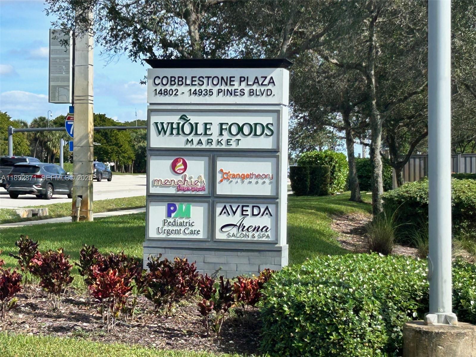 430 Southwest 147th Avenue Pembroke Pines, FL 33027 - Photo 34 of 36 a sign that is on a pole on a street