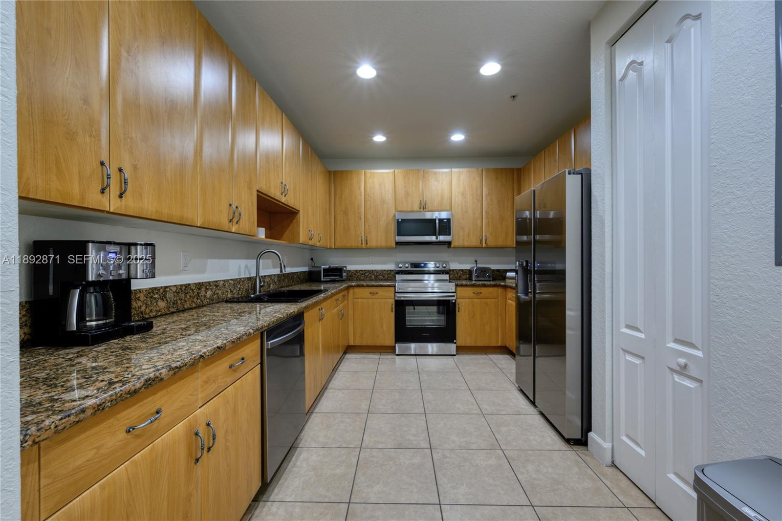 430 Southwest 147th Avenue Pembroke Pines, FL 33027 - Photo 6 of 36 a kitchen with stainless steel appliances granite countertop granite top and stainless steel appliances