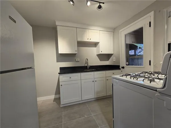 a kitchen with a stove and a refrigerator