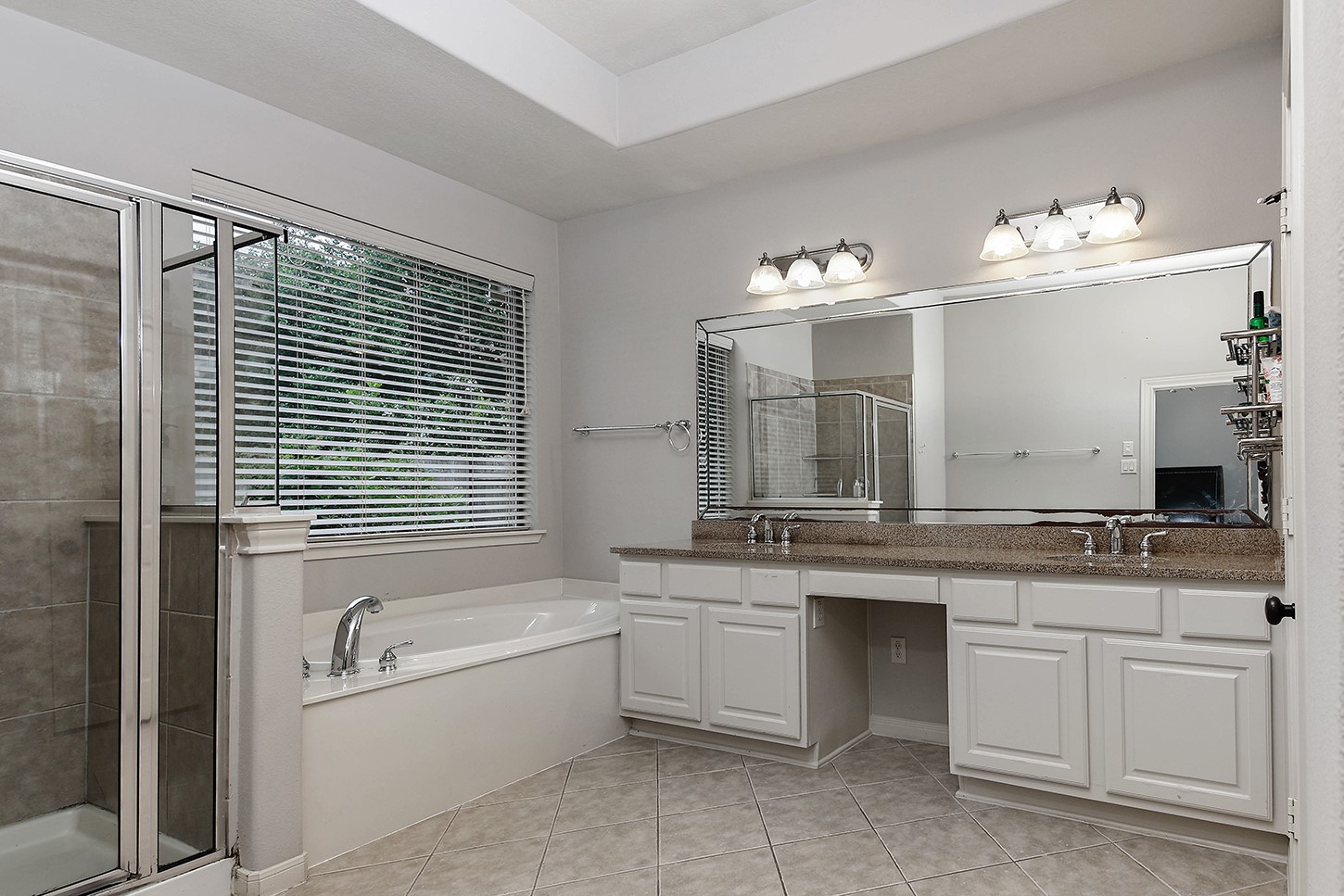 18722 Duke Lake Drive Spring, TX 77388 - Photo 15 of 26 a bathroom with a tub sink and mirror