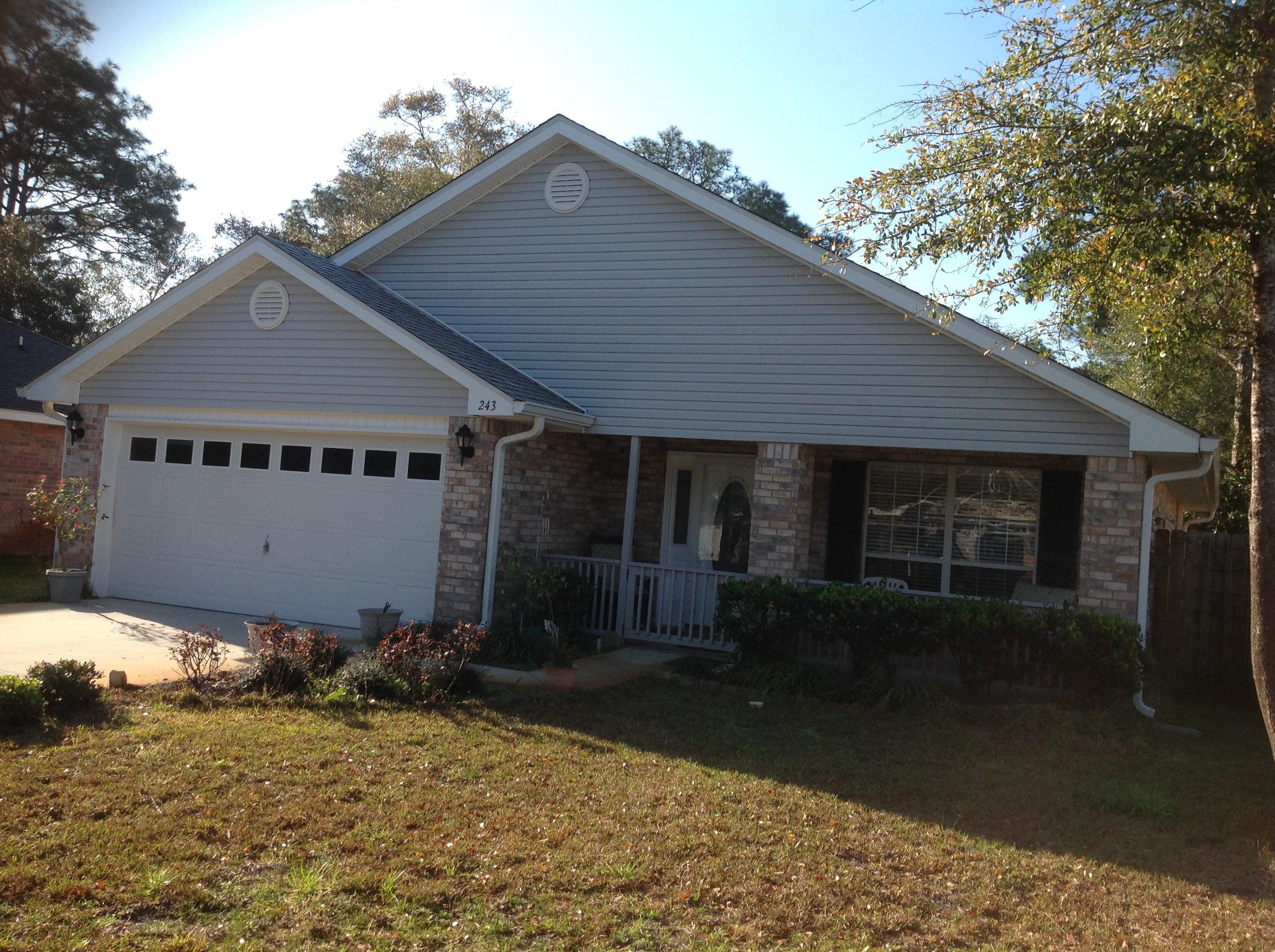 243 Bayou Landing Road Santa Rosa Beach, FL 32459 - Photo 3 of 28 a front view of a house with a yard