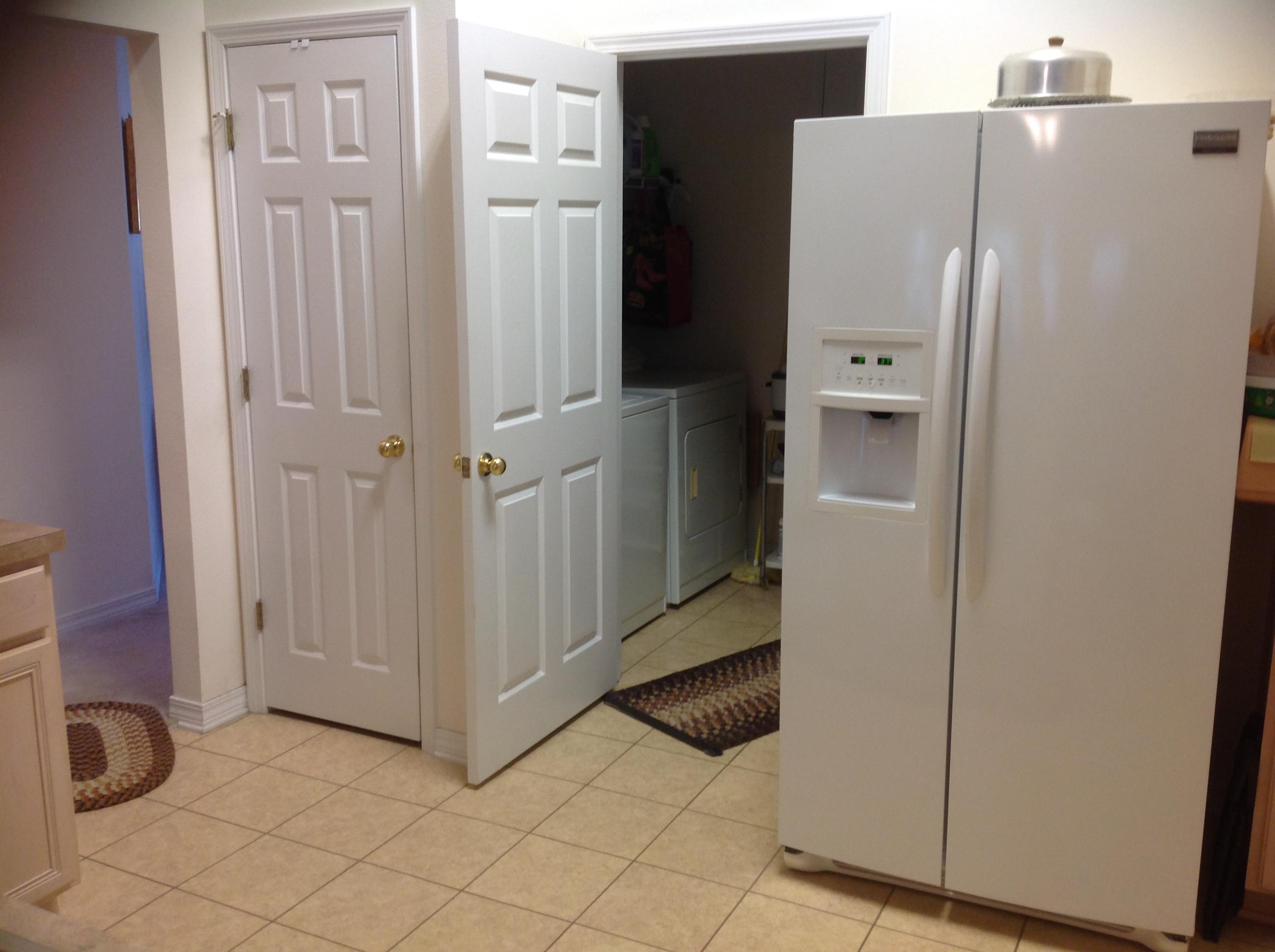 243 Bayou Landing Road Santa Rosa Beach, FL 32459 - Photo 8 of 28 a view of a refrigerator in kitchen and an empty room
