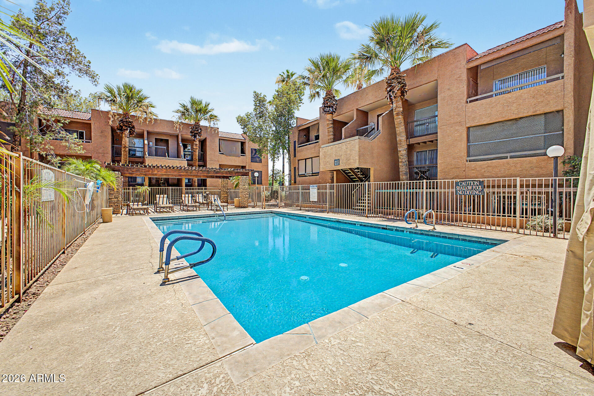 2625 East Indian School Road, Unit 227 Phoenix, AZ 85016 - Photo 27 of 31 a view of a swimming pool with a lounge chairs