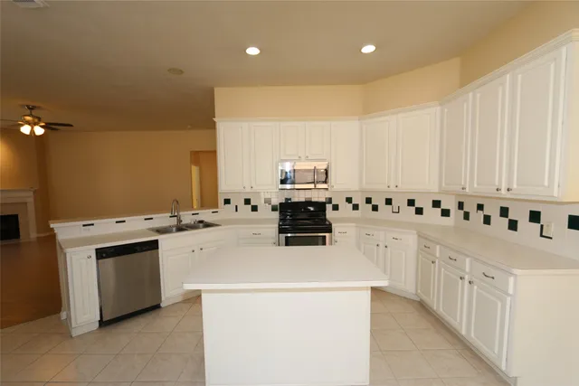 a kitchen with cabinets a sink and appliances