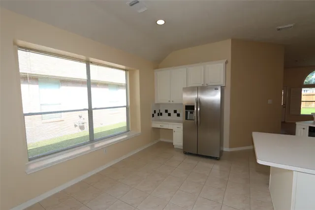 a room with a bed and a large window