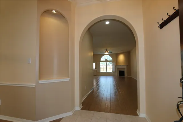a view of empty room with wooden floor