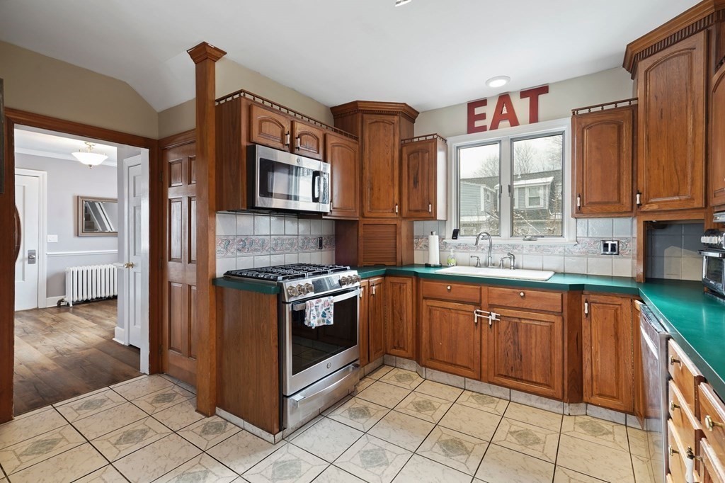 53 Pond Street Canton, MA 02021 - Photo 14 of 31 a kitchen with stainless steel appliances granite countertop a stove a sink and a microwave