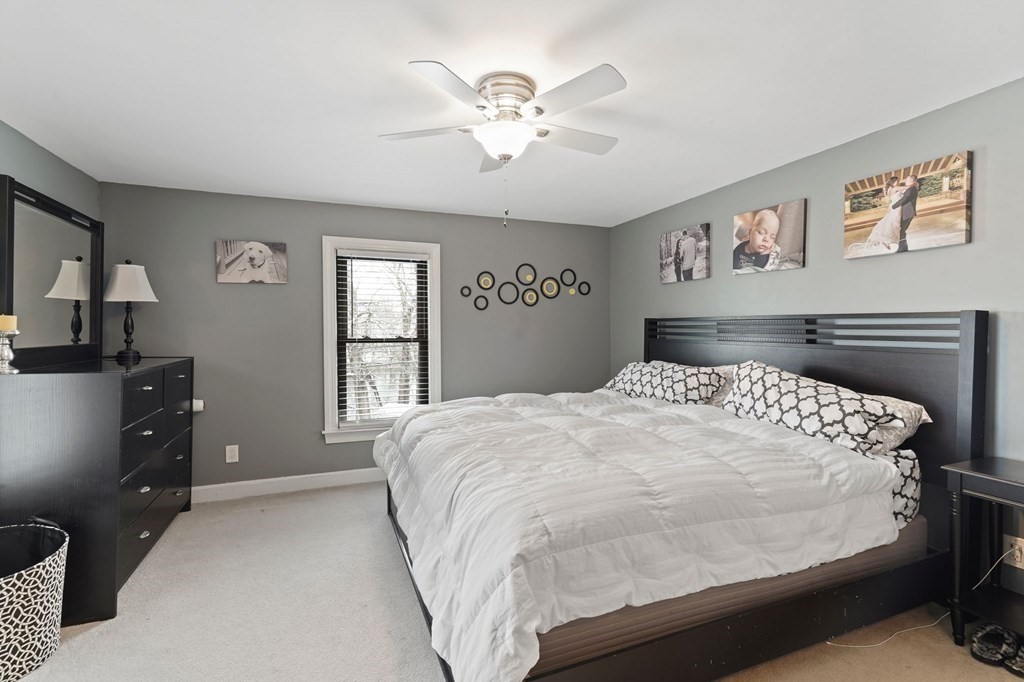 53 Pond Street Canton, MA 02021 - Photo 17 of 31 a bedroom with a large bed and a chandelier