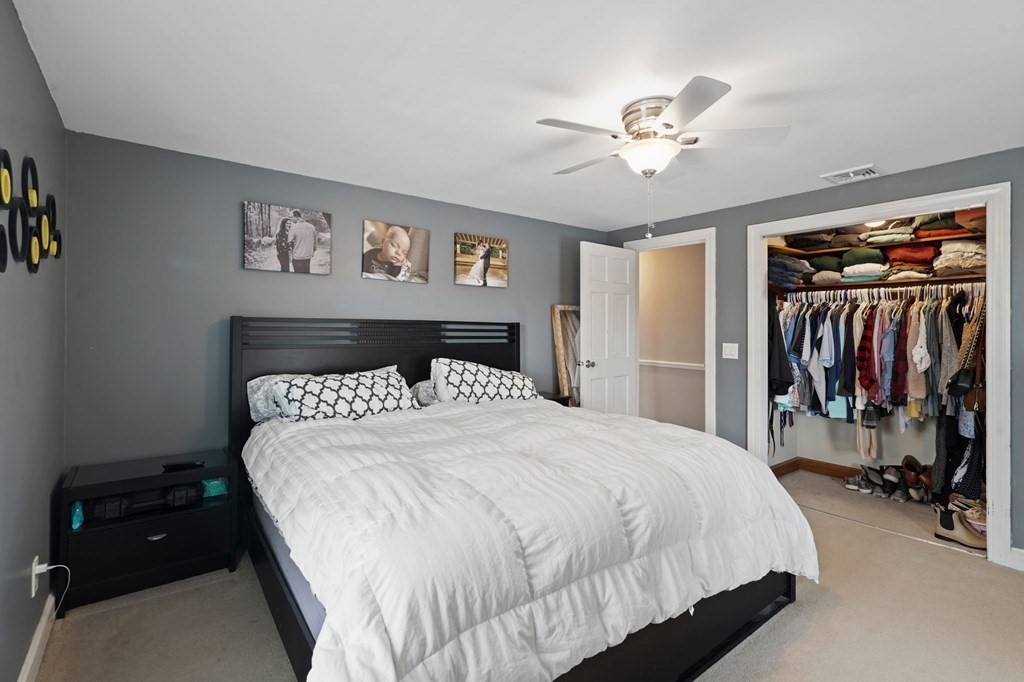 53 Pond Street Canton, MA 02021 - Photo 18 of 31 a bedroom with a large bed and a chandelier