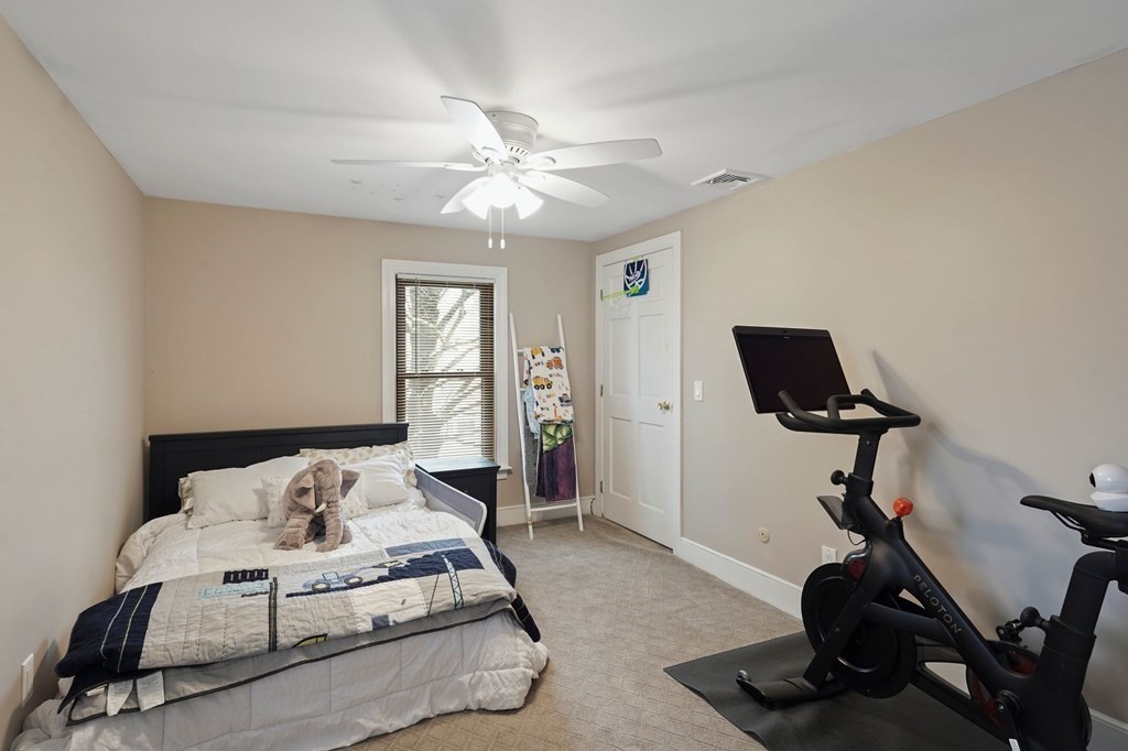 53 Pond Street Canton, MA 02021 - Photo 23 of 31 a bedroom with a bed and a chandelier