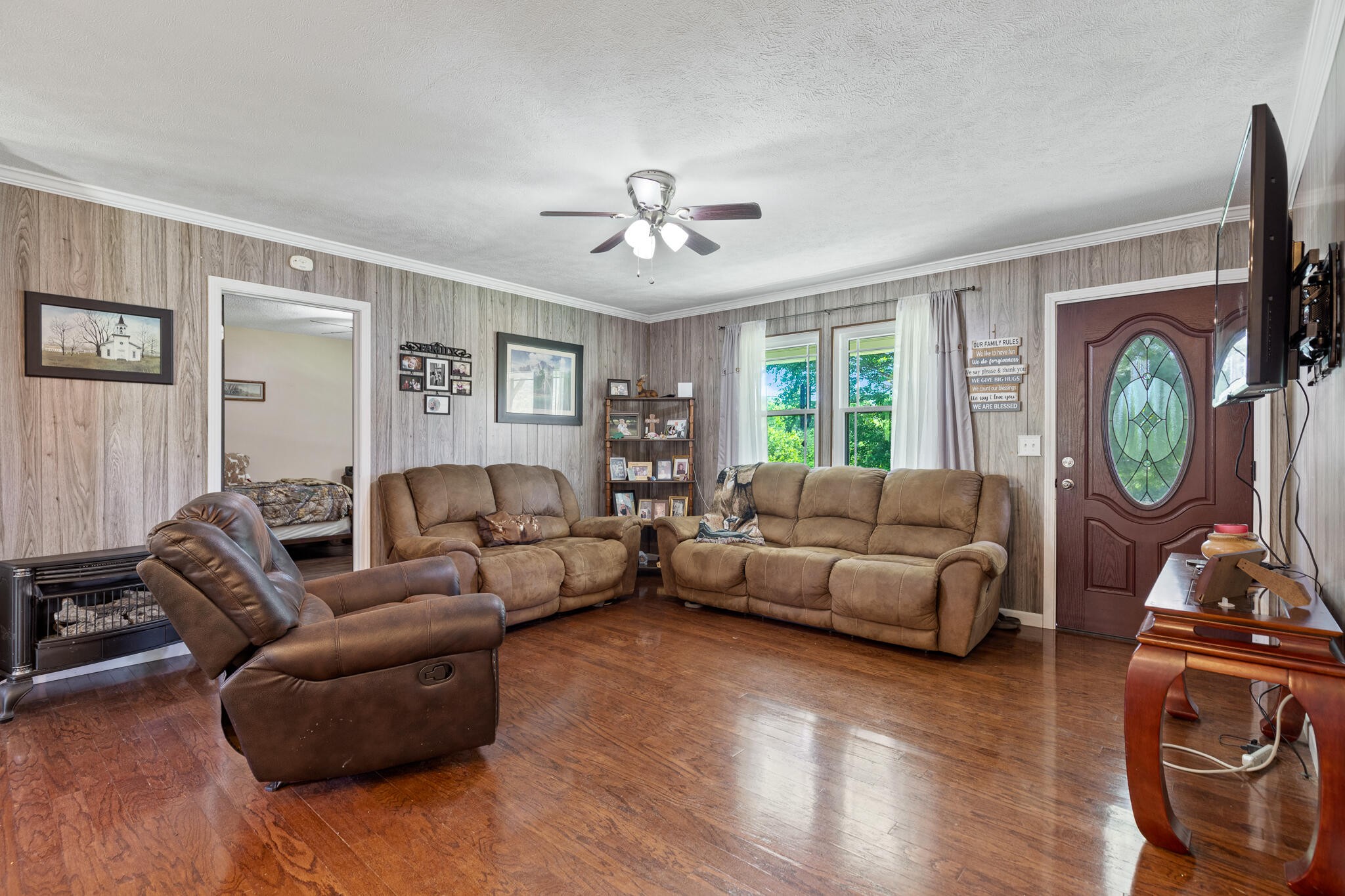 219 Corbin Lake Road Rutledge, TN 37861 - Photo 8 of 41 a living room with furniture a fireplace and a flat screen tv