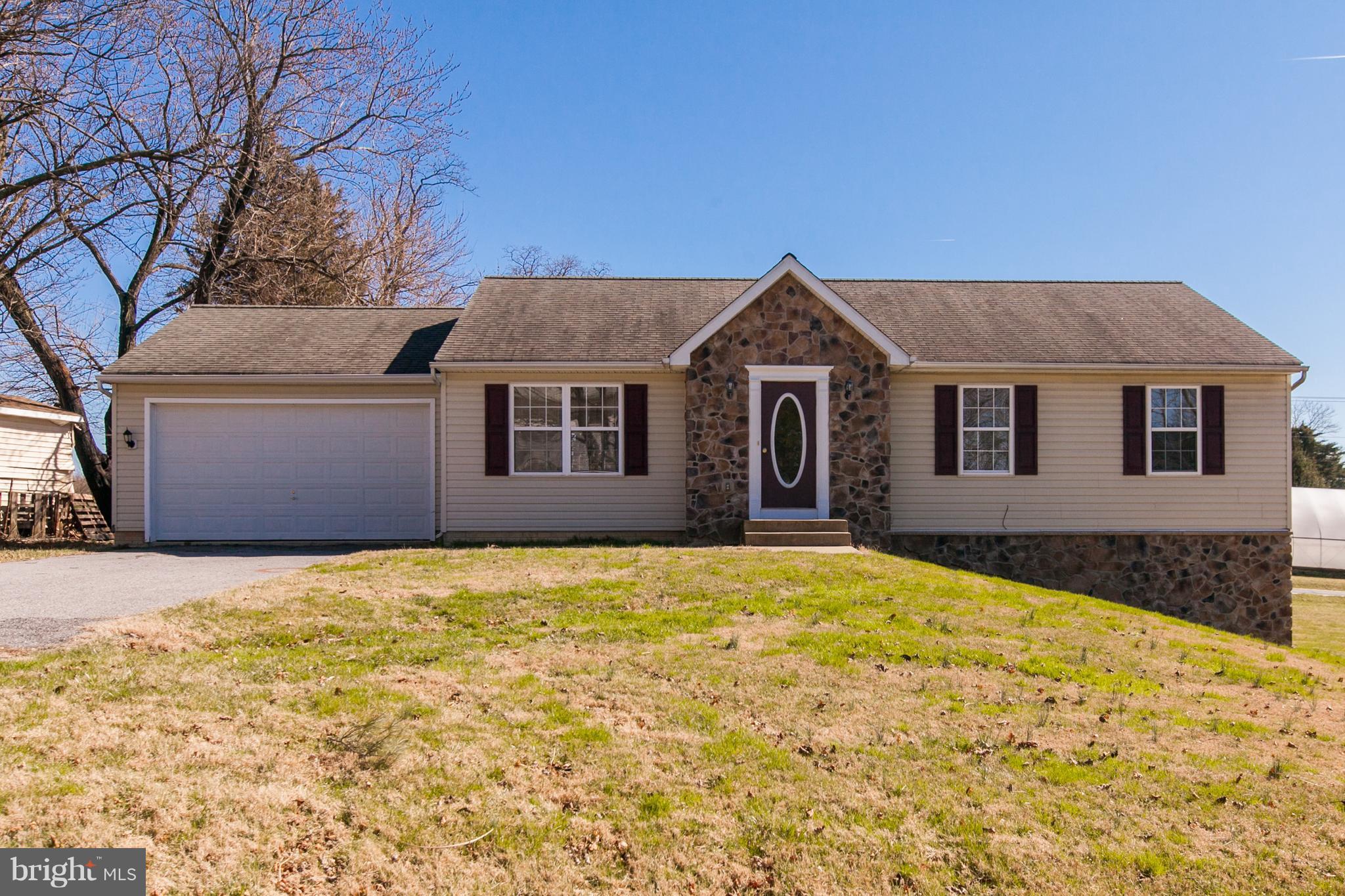 14613 Toll Road New Windsor, MD 21776 - Photo 1 of 30 a front view of a house with a yard