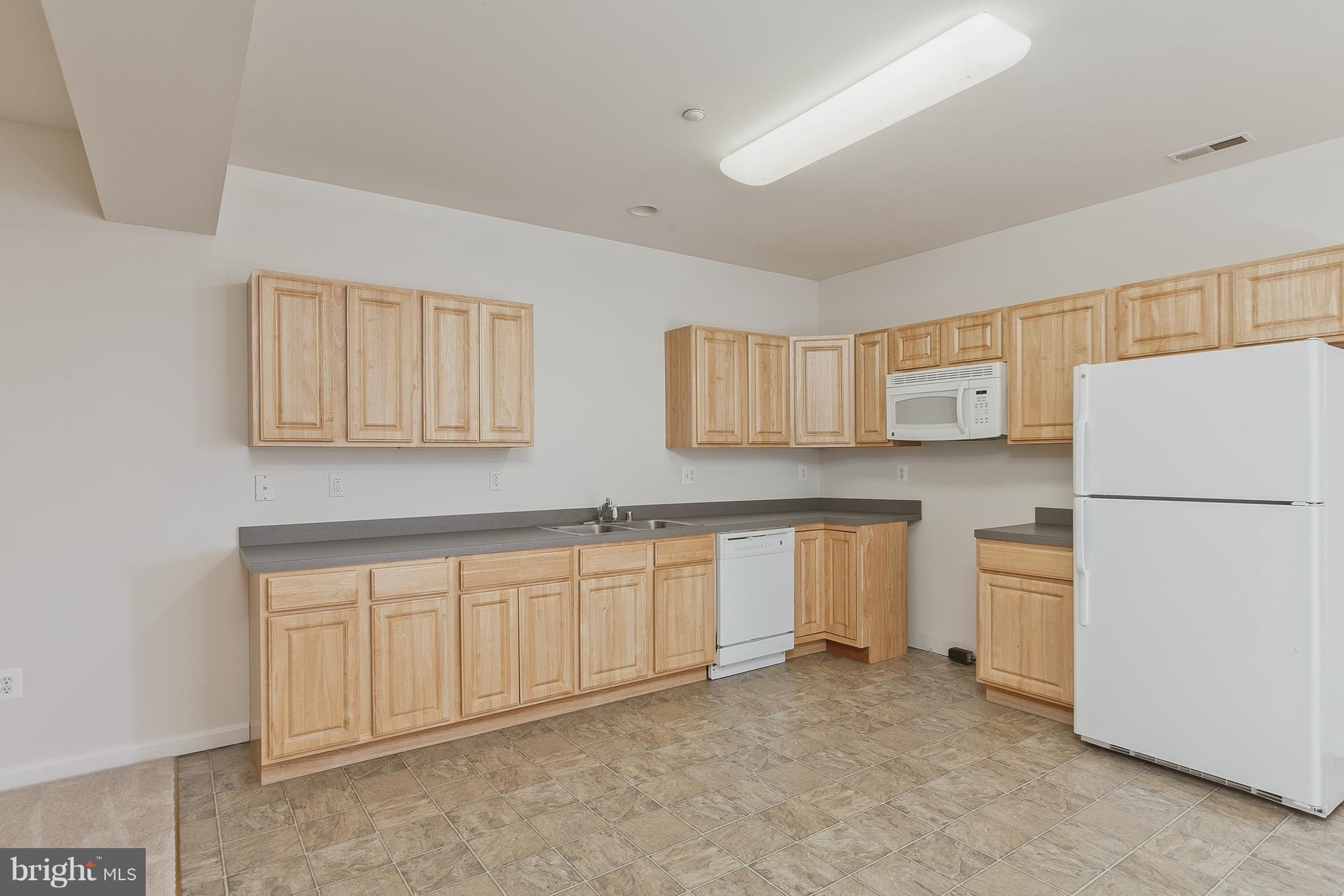14613 Toll Road New Windsor, MD 21776 - Photo 19 of 30 a kitchen with granite countertop white cabinets and refrigerator