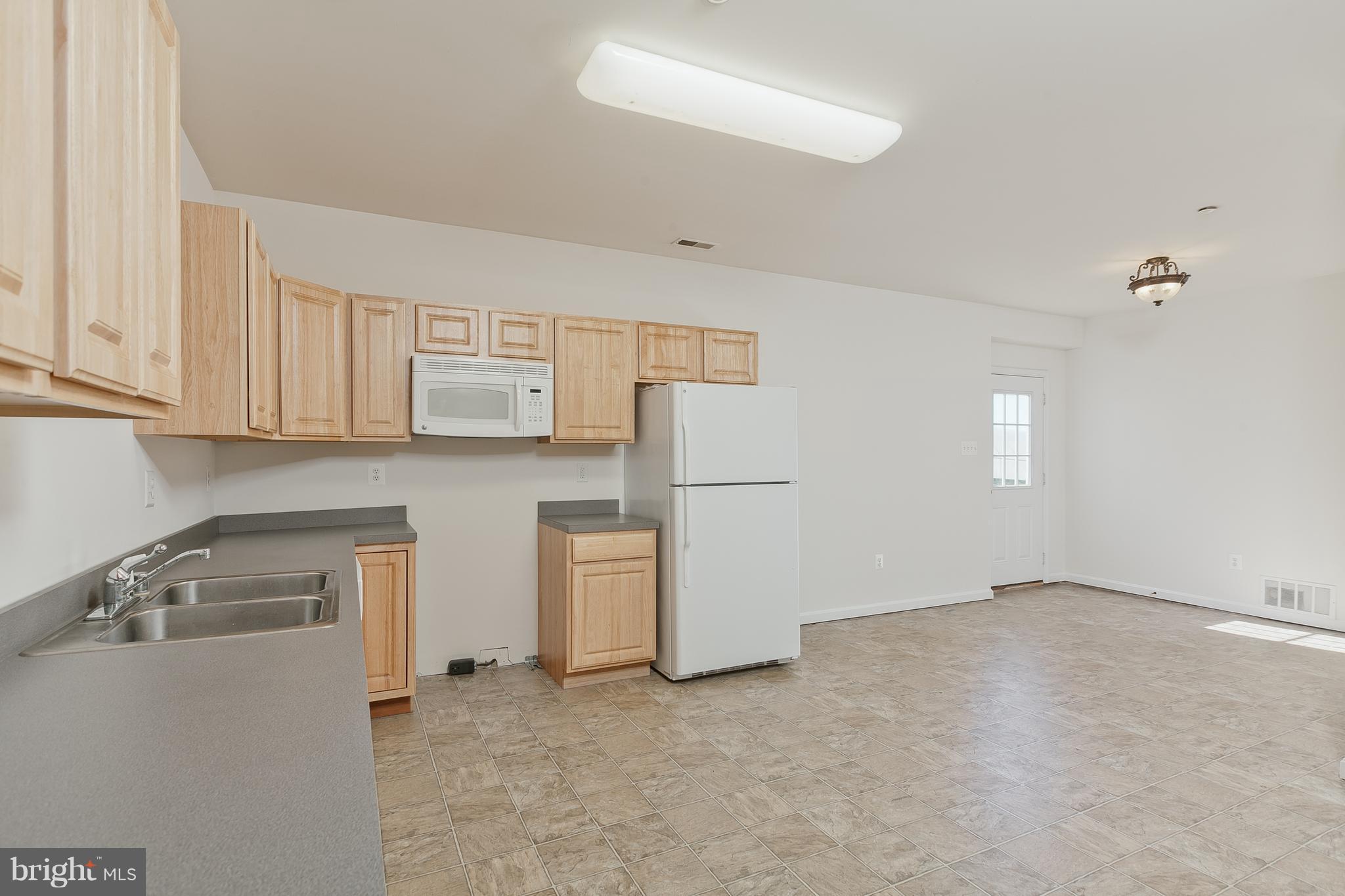 14613 Toll Road New Windsor, MD 21776 - Photo 20 of 30 a kitchen with white cabinets and a stove