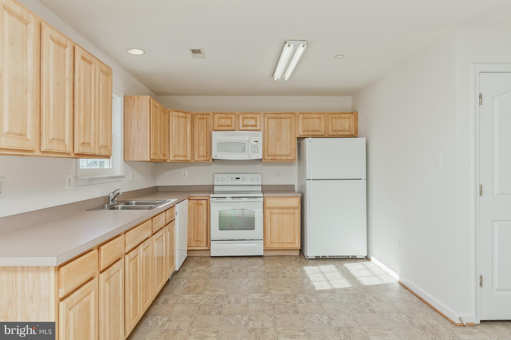 14613 Toll Road New Windsor, MD 21776 - Photo 7 of 30 a kitchen with granite countertop white cabinets and white appliances