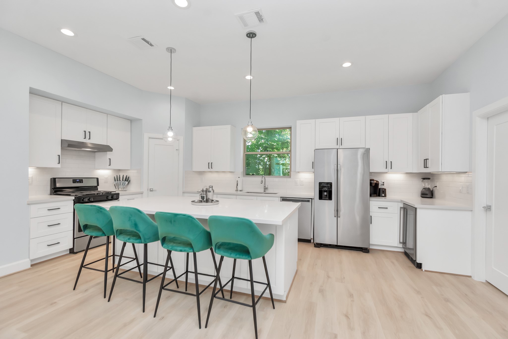 3310 Pease Street, Unit B Houston, TX 77003 - Photo 15 of 50 a kitchen with white cabinets and stainless steel appliances