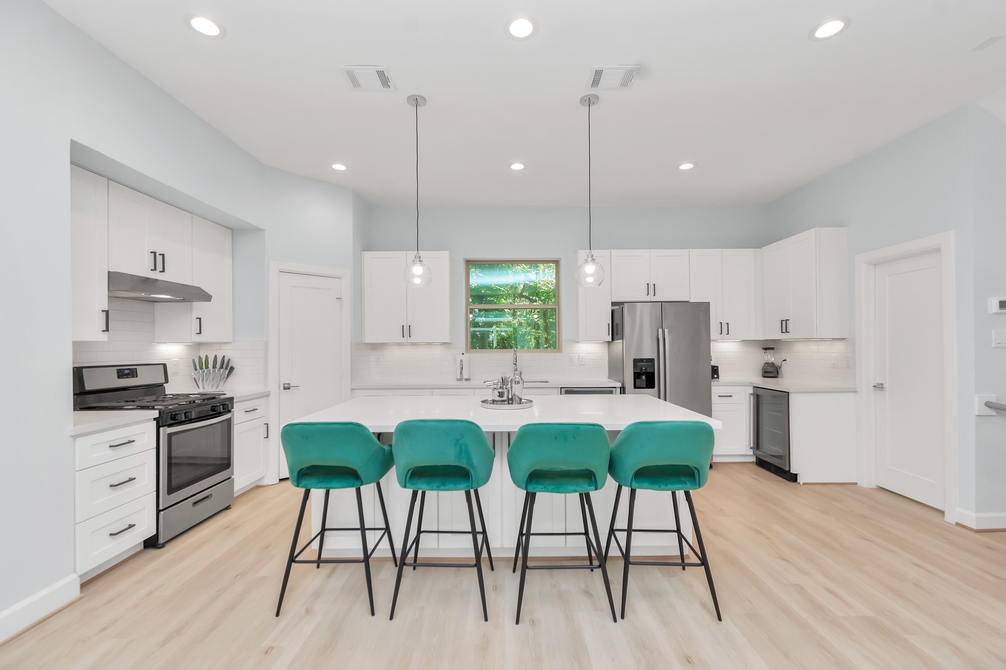 3310 Pease Street, Unit B Houston, TX 77003 - Photo 16 of 50 a kitchen with stainless steel appliances kitchen island a large island in the center