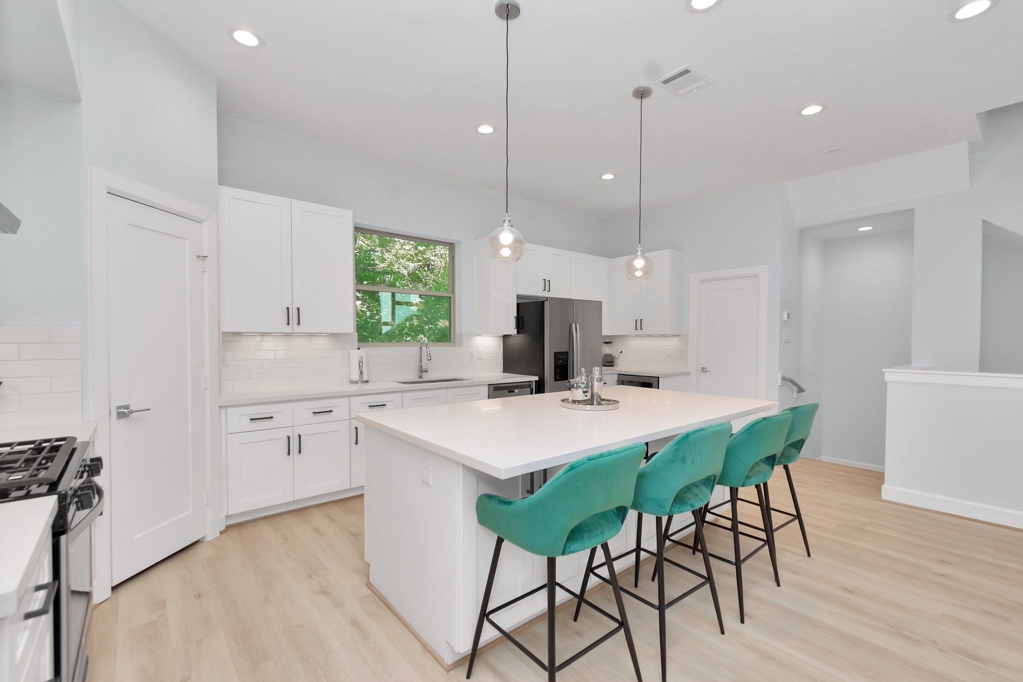 3310 Pease Street, Unit B Houston, TX 77003 - Photo 17 of 50 a kitchen with stainless steel appliances a table and chairs in it